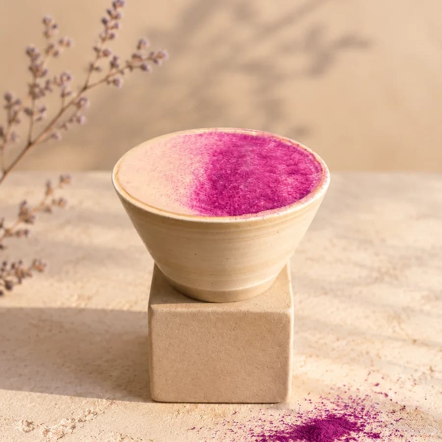 Ceramic bowl filled with purple yam powder, set on a stone cube